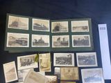 a lot of old photographs on display on a table