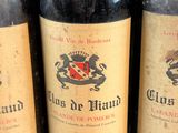 several bottles of wine are lined up on a table