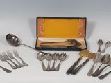 a lot of spoons and forks in a box
