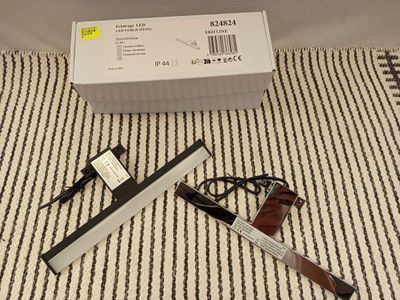 a box with a pen and a pair of scissors on the floor