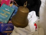 a bell that is sitting on a bed next to some books
