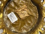a close up of a gold plate with a label on it