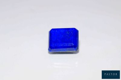 a close up of a blue square stone on a white surface