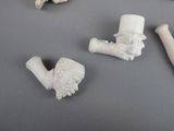 four pieces of white clay that are on a table