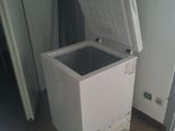 a white chest freezer sitting on a tiled floor