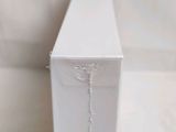 a white box with a string attached to it