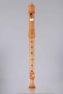 a close up of a wooden flute on a white surface