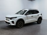 the white suv is parked in a white room with a black floor