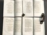 four open books on a table with a pair of scissors