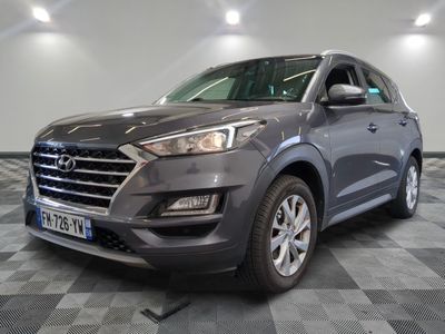 the front view of a grey suv parked in a garage