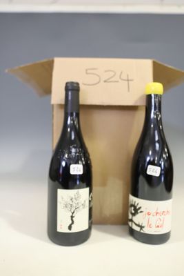 two bottles of wine sitting next to each other on a table