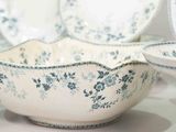many plates and bowls that are on the table