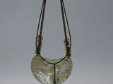 an image of a necklace on a stand on a white background