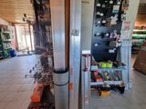 a refrigerator in the middle of a room with a lot of items on the floor