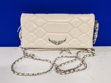 a white quilted purse with a chain around it