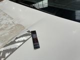 a remote control sitting on the hood of a car