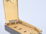 a black and gold suitcase with a key in it