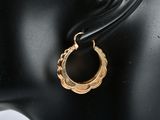 a close up of a pair of earrings on a mannequin head