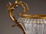 a glass vase with a gold decoration on it