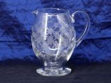 an image of a clear glass pitcher on a black surface