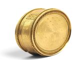 a gold coin sitting on top of a white surface