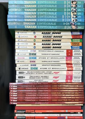 many books stacked on top of each other on a shelf