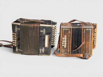 pair of antique accordions on a white background