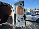 a white van with the door open in a parking lot