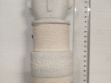 a stack of three cakes on a shelf next to a ruler