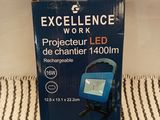 an image of a box of excellence work light on a bed