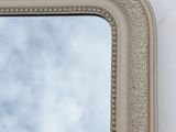 a mirror on the wall with a sky in the background