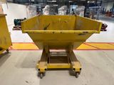 a large yellow dumpster sitting in the middle of a warehouse