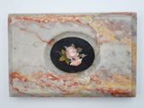 a picture of a marble box with a rose on it