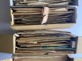 a stack of papers in a cardboard box on a table