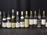 several bottles of wine are lined up on a table