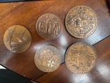 four coins sitting on top of a wooden table next to a keyboard