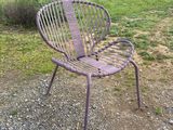 a purple chair and a table in a field
