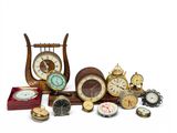 many different types of clocks sitting on a table