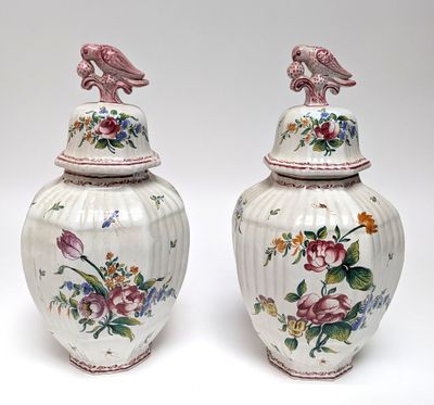 pair of vases with birds and flowers painted on them on a white background