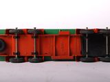 a red and green toy train on a white surface