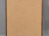 an old picture frame with a piece of brown paper on it