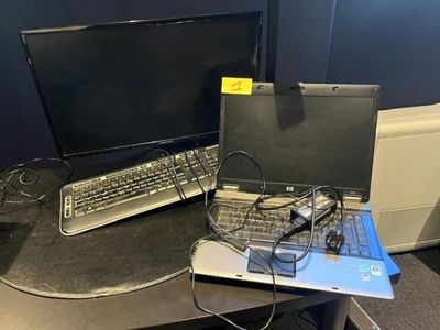 a laptop computer sitting on top of a desk next to a monitor