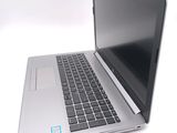 a laptop computer that is open on a white surface