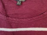 the back of a maroon and white striped shirt with a black and white stripe on it
