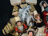 a group of dolls that are sitting on a black surface