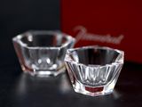 two small glass bowls sitting next to each other on a table