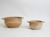 two small bowls and a small bowl on a white surface