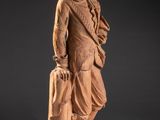 a statue of a man in a suit and tie holding a briefcase