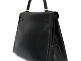 a black leather handbag on a white background