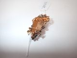 a gold brooch on a white background with a price tag on it